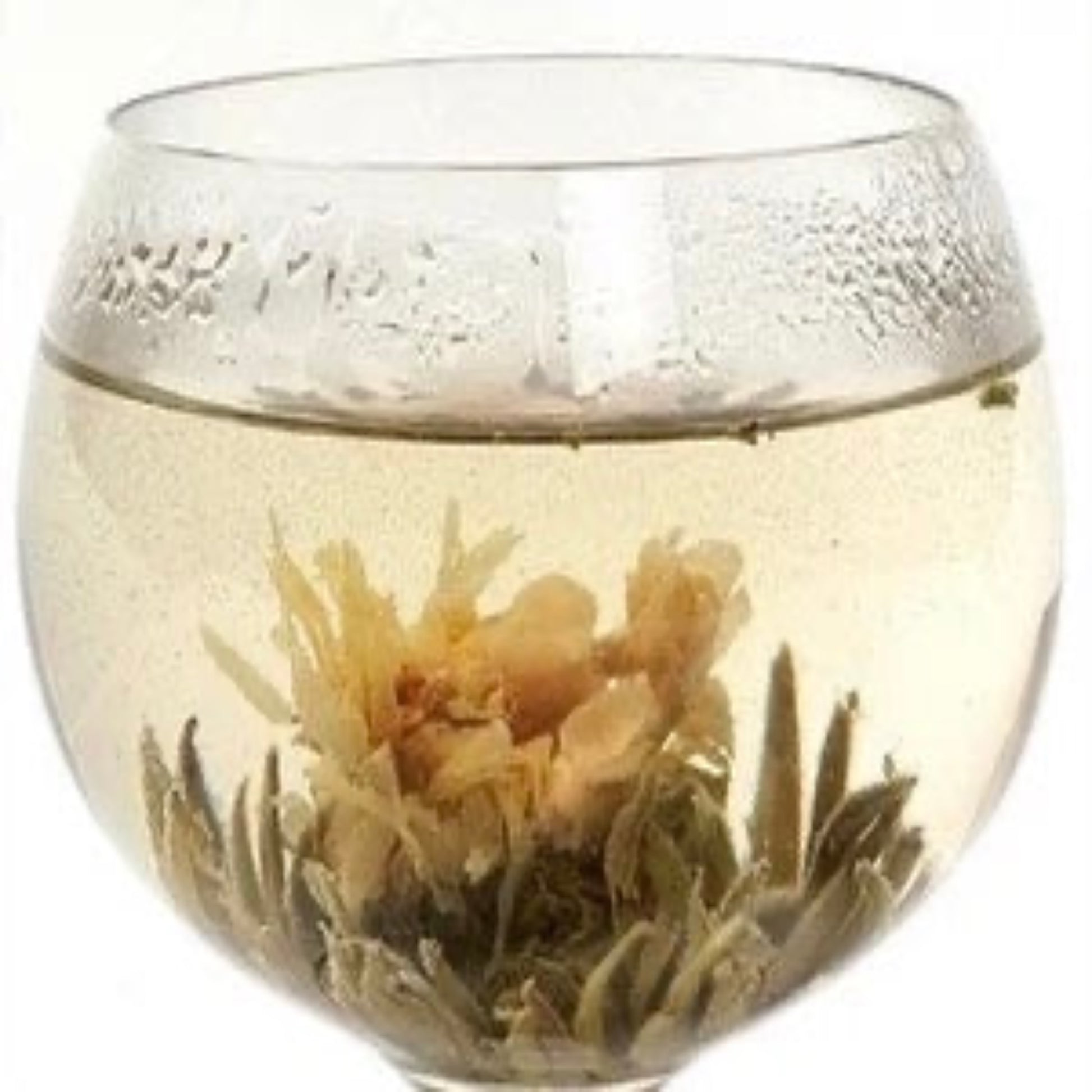 Blooming tea ball in glass of hot water
