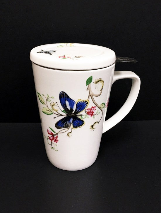 White tea mug with a lid.  It has a decoration of a butterfly and red flower vine.