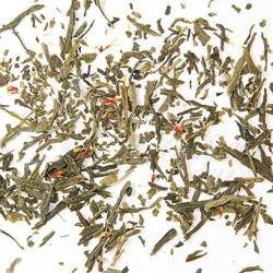 A sprinkling of green tea leaves with small pieces or orange peal peeking throughout on a background of white.