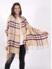 Lady wearing a beige and red plaid blanket scarf. 