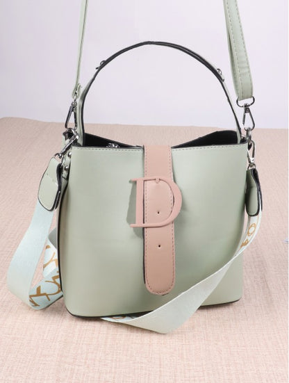 Light green handbag with D shaped buckle. 