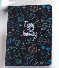 Black Travel Journal with White Print “Enjoy The Journey” decorated with drawings of travelling items.  6561114030244