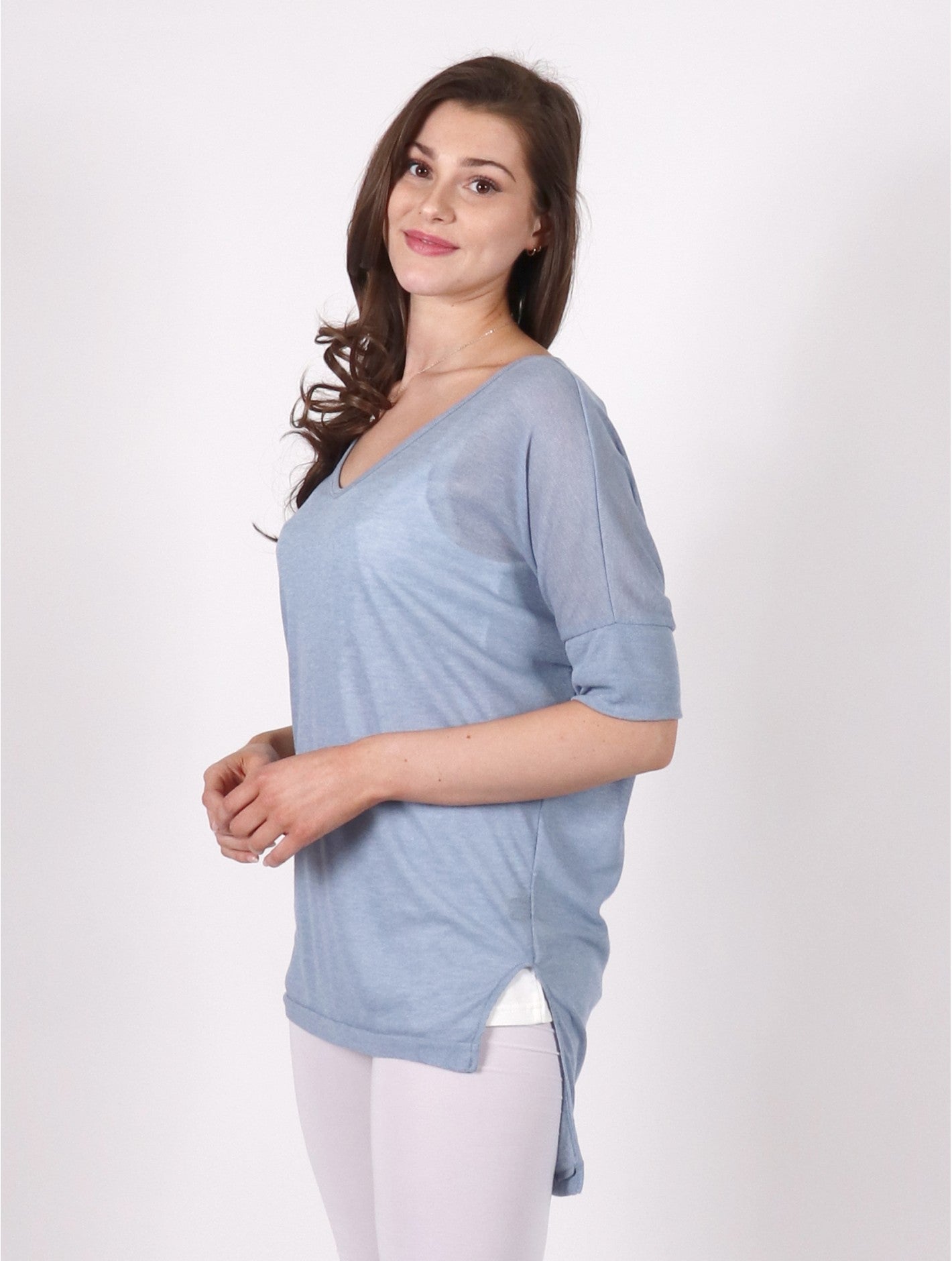 Light blue 1/2 length sleeve v-neck top.   The back of the top is longer than the front.