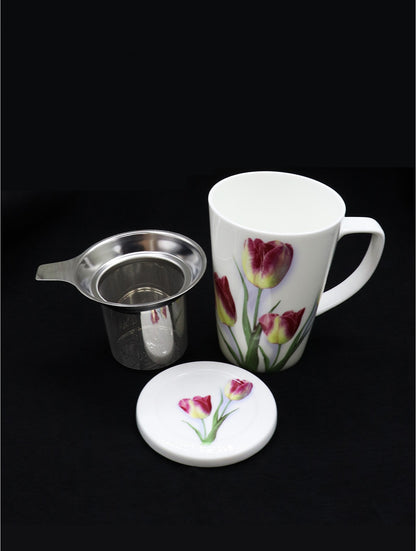 White porcelain tea mug decorated with 3 tulips.  Beside it lays the  infuser that sits in the mug and the lid.  The lid is decorated with a small picture of tulips.