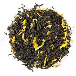 Loose Leaf Monks Blent Tea with calendula petals sprinkled in it.  The tea is arranged in a circle.  6056092762276